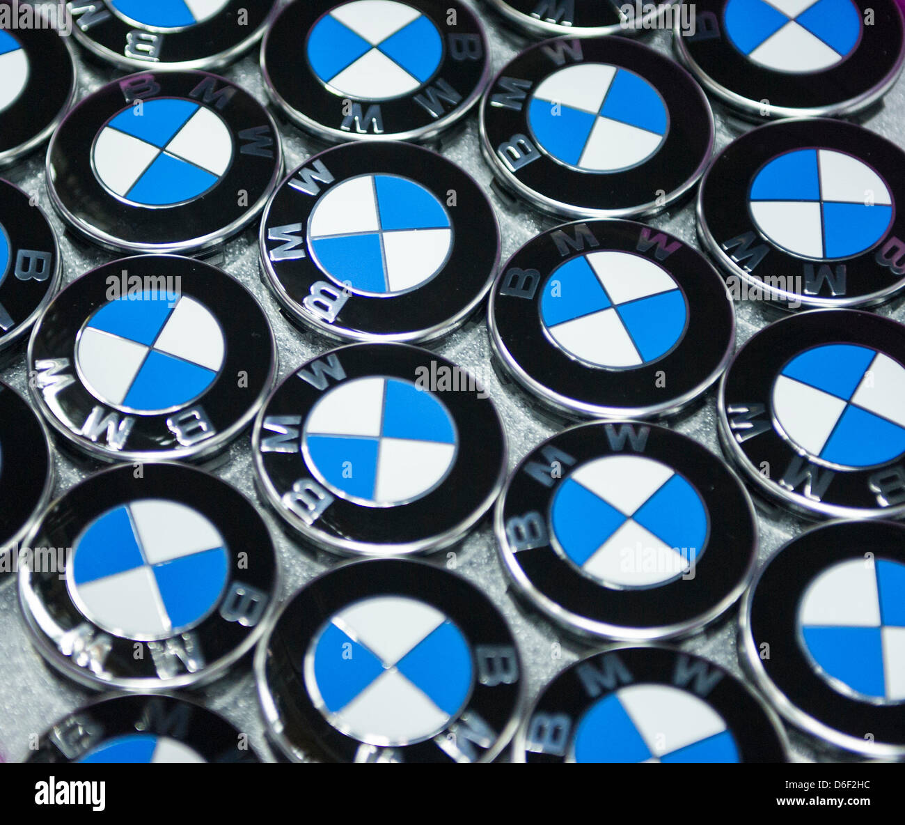 Caps with the logo of BMW lie in a box at the factory of car manufacturer BMW in Regensburg, Germany, 10 April 2013. Photo: Marc Mueller Stock Photo