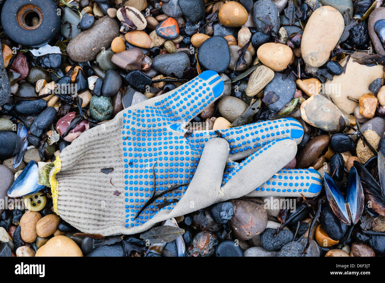 Gloves among the pebbles on the River Tyne North Sheilds, Tyne and Wear, UK Stock Photo