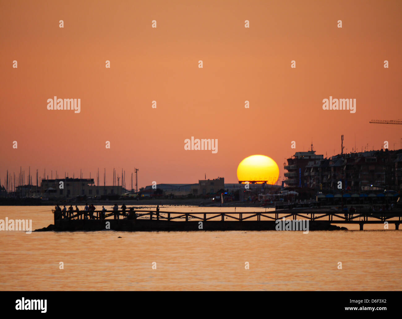 the sun sets behind the harbor of Ostia, Rome Stock Photo
