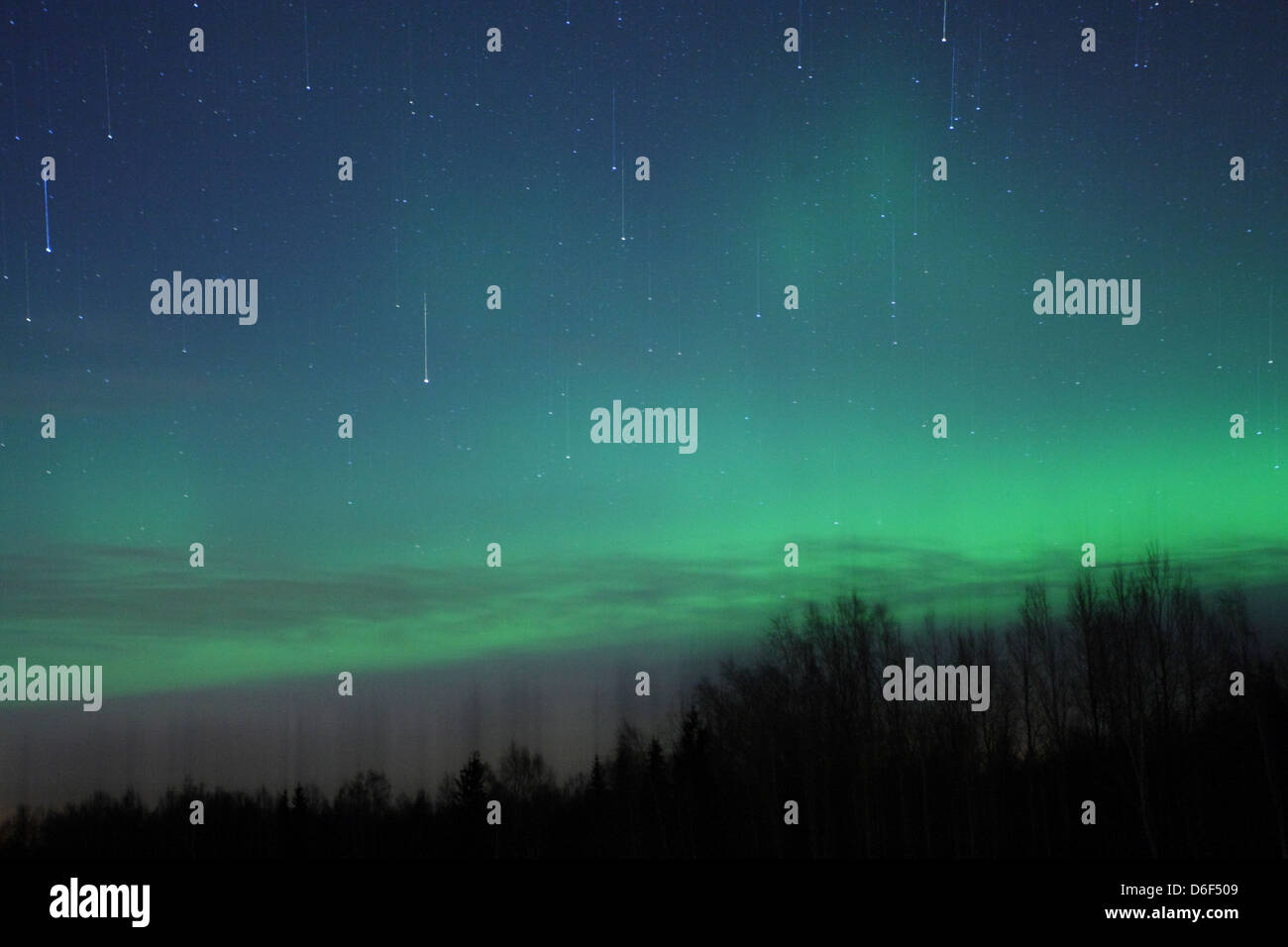 Falling stars and Northern lights (Aurora Borealis) in the sky. Europe