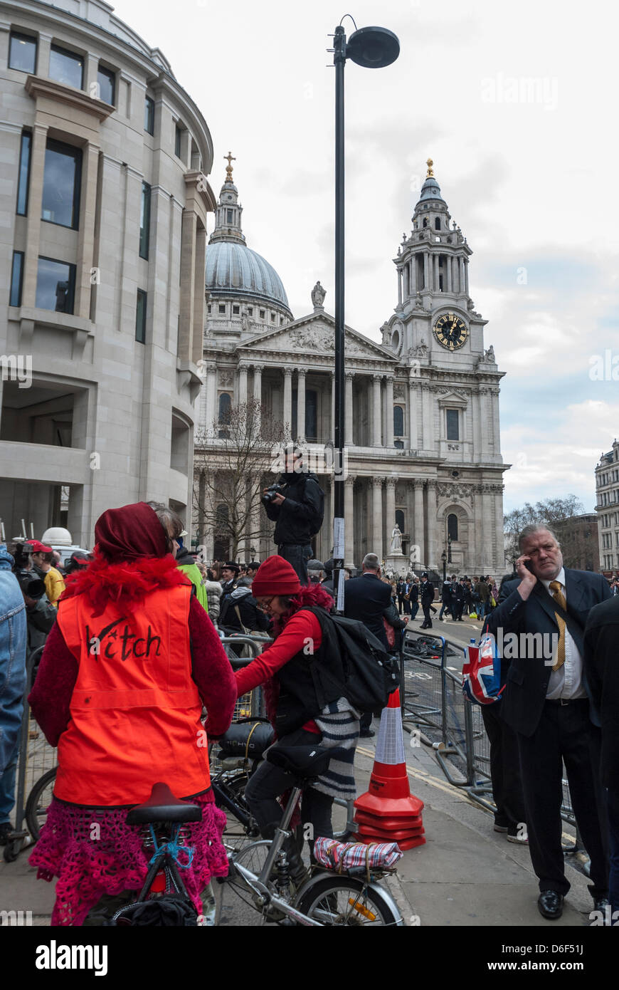 London, UK. 17th April, 2013. A protester with her reflecter jacket written `Witch` on it at the front of St Paul's Cathedral, in London. Stock Photo