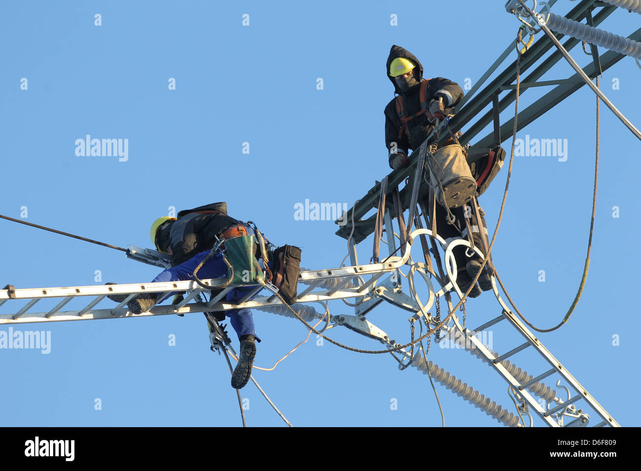 Rendsburg, Germany, workers replace insulators on high voltage pylons Stock Photo