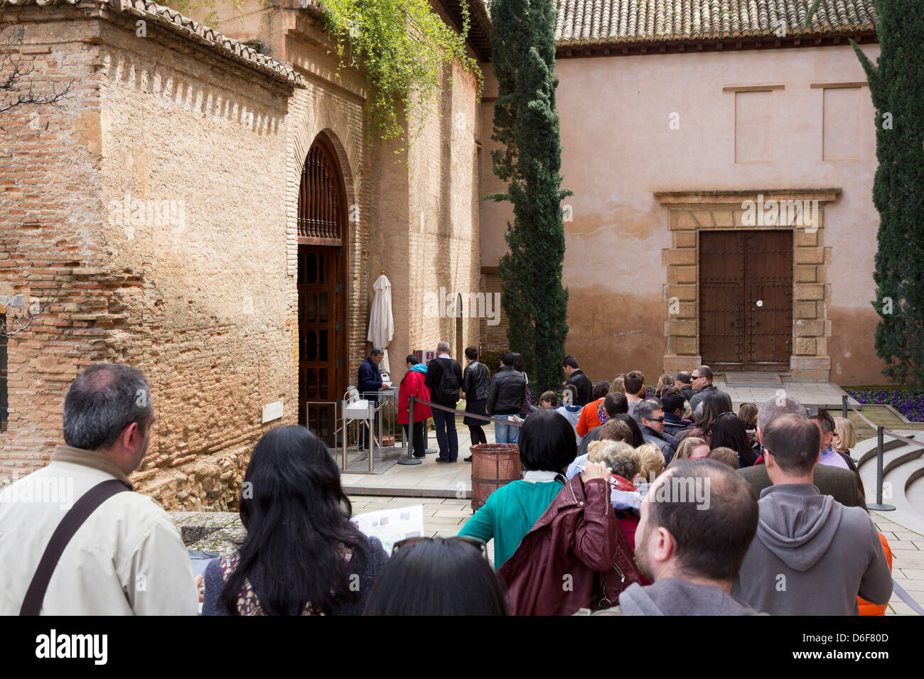 A line of tourists await entry to the Nasrid Palaces, the Alhambra, Granada Stock Photo
