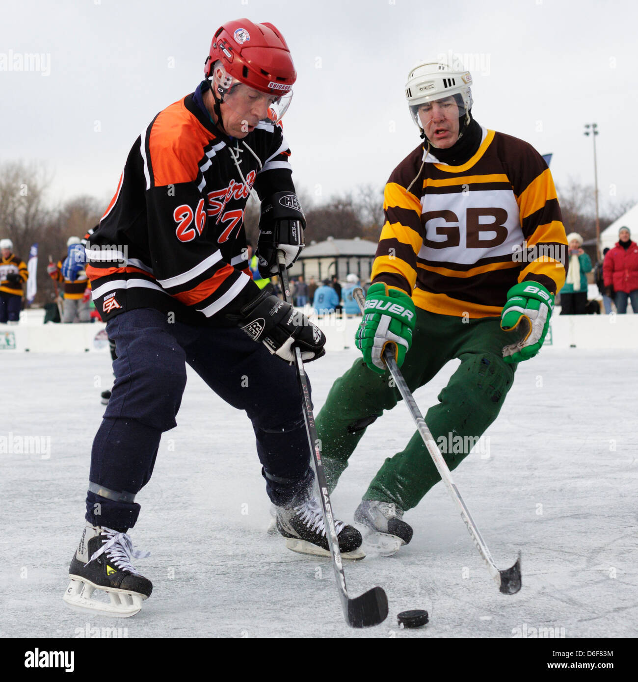 Two men vie for the puck during a game at the U.S. Pond Hockey Championships on Lake Nokomis in Minneapolis, Minnesota. Stock Photo