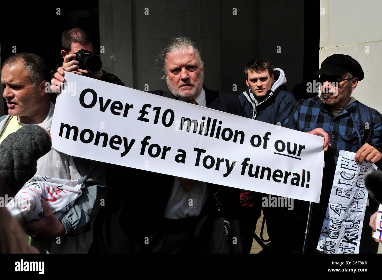 Protesters outside St Paul's Cathedral hold a banner reading ' Over £10 million of our money for a Tory funeral' . London, UK Stock Photo
