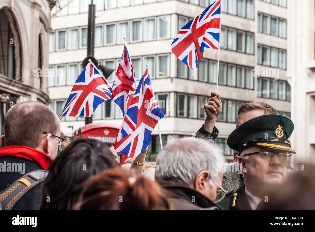 Supporters holding Union Jack flags at the funeral of Lady Thatcher, London, England, UK. Stock Photo