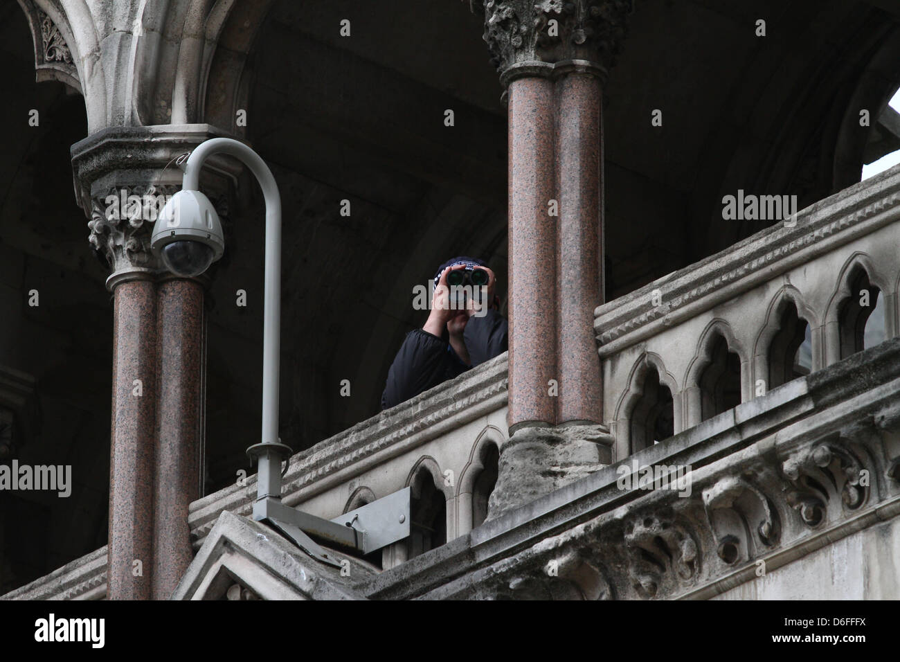 London, UK. 17th April 2013. The Funeral of Baroness Margaret Thatcher. A police spotter with binoculars at the Royal Courts of Justice. The Funeral service takes place in St. Paul's Cathedral, London. Pic: Paul Marriott Photography/Alamy Live News Stock Photo