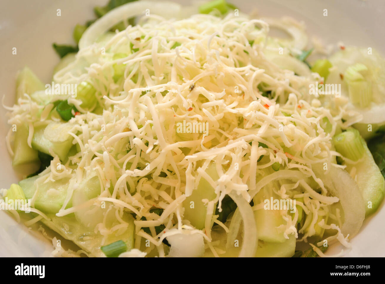 Shredded Cheese on Top of Sliced Cucumbers Stock Photo