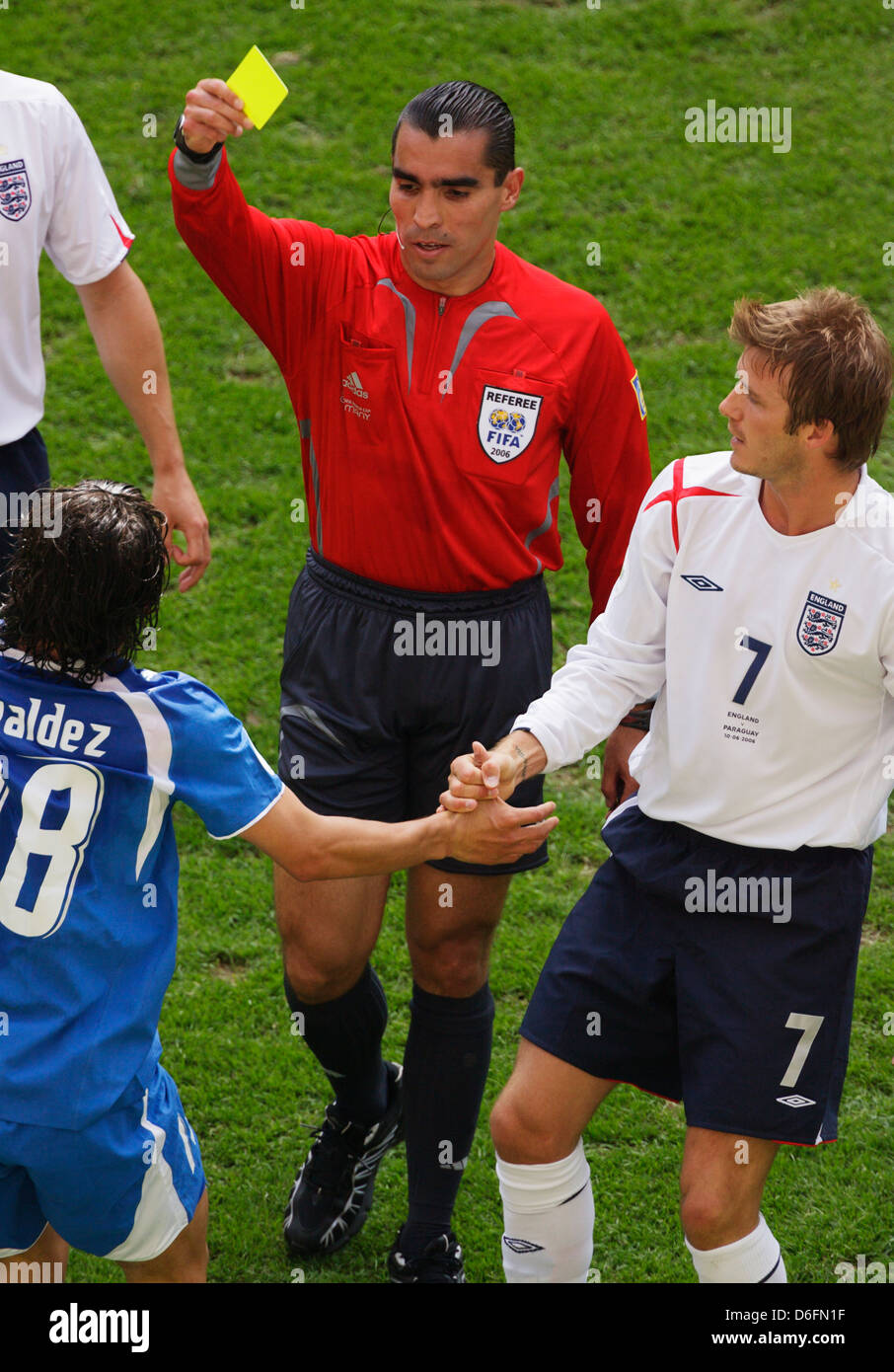 Referee Marco Rodriguez issues a yellow card to Nelson Valdez of Paraguay as David Beckham of England looks on; 2006 World Cup Stock Photo