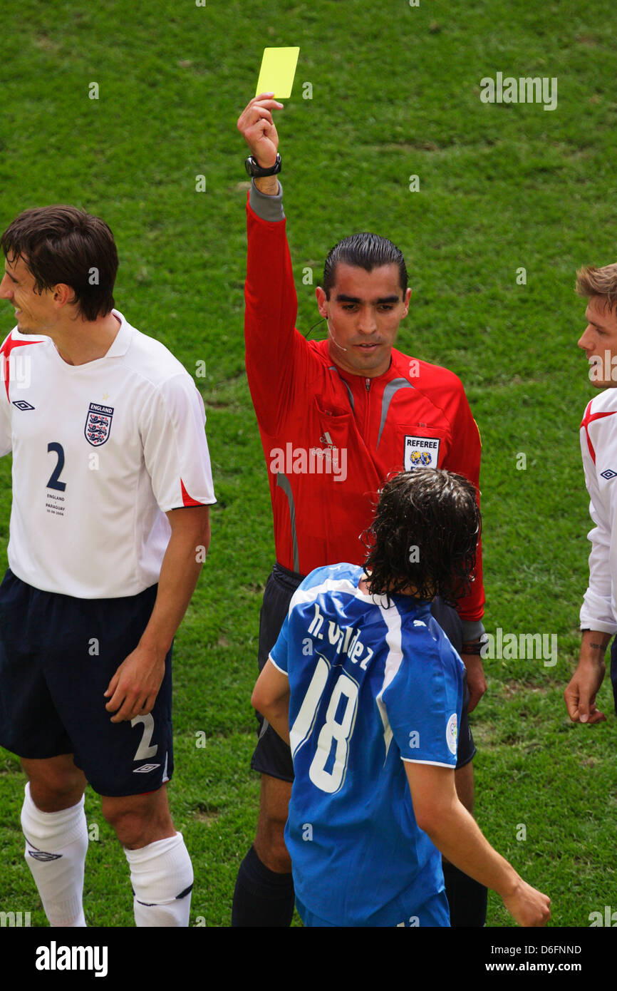 Referee Marco Rodriguez (MEX) issues a yellow card caution to Nelson Valdez of Paraguay during a 2006 FIFA World Cup match. Stock Photo