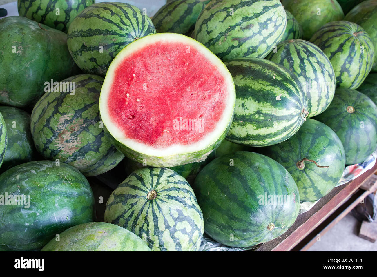 Watermelons Seedless Whole and Halved at Fruit Stand Stock Photo