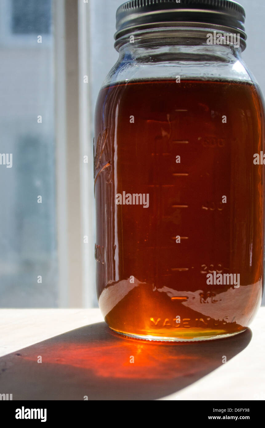 A glass mason jar full of fresh maple syrup Stock Photo Alamy