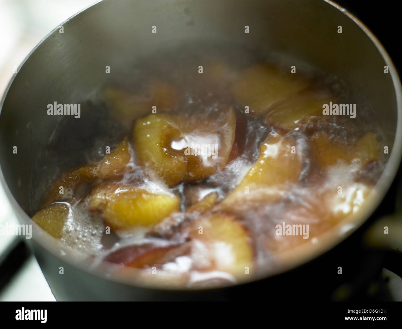 Plums in syrup - with recipe / step shot Stock Photo