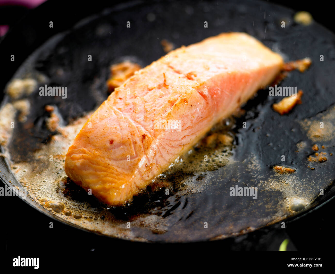 Salmon fillet cooking in butter/step shot Stock Photo
