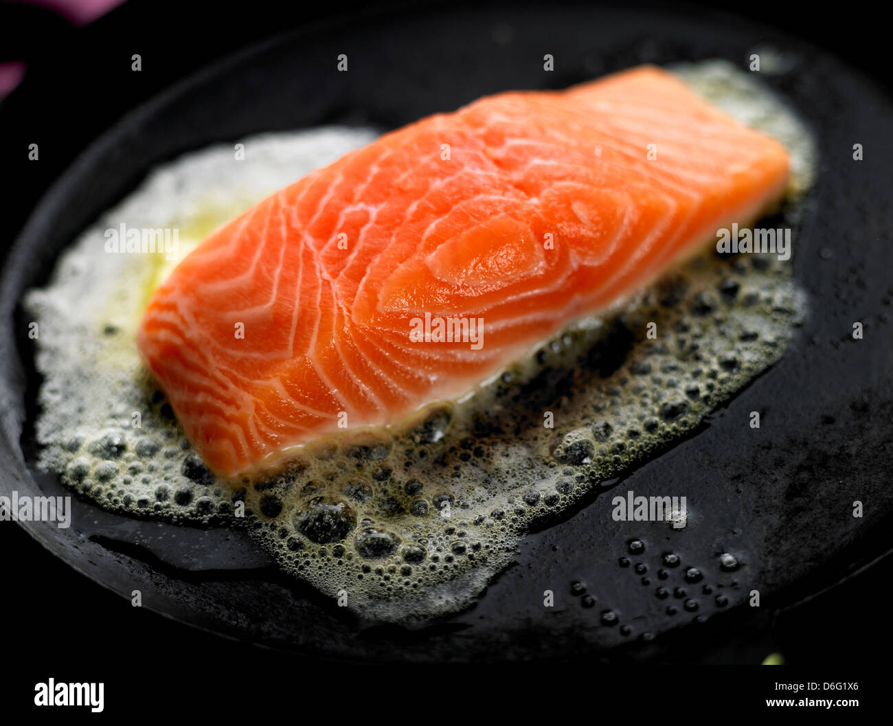 Searing Salmon in butter/ step shot Stock Photo