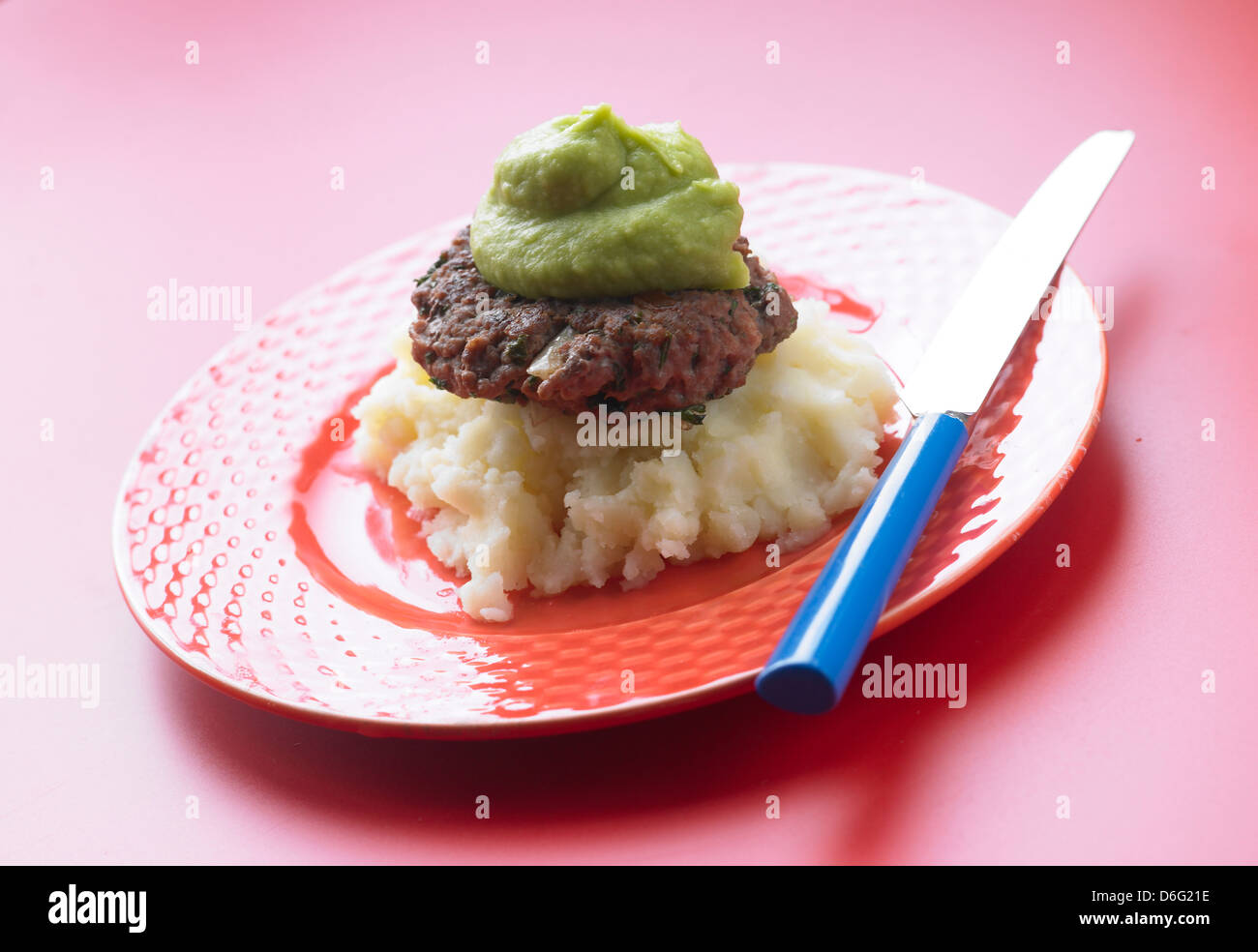Kids home made burger on mash with puree peas - with recipe Stock Photo