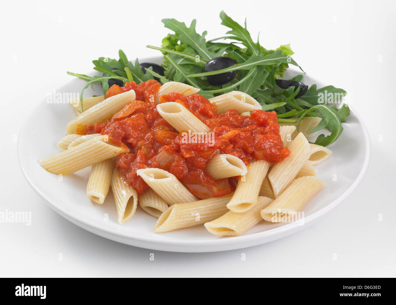 Penne with tomato sauce and rocket Stock Photo