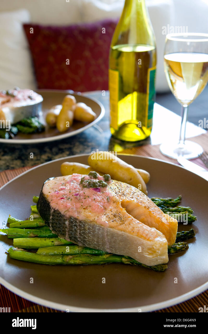 Roasted Salmon and Asparagus with a lemon and caper sauce - with recipe Stock Photo