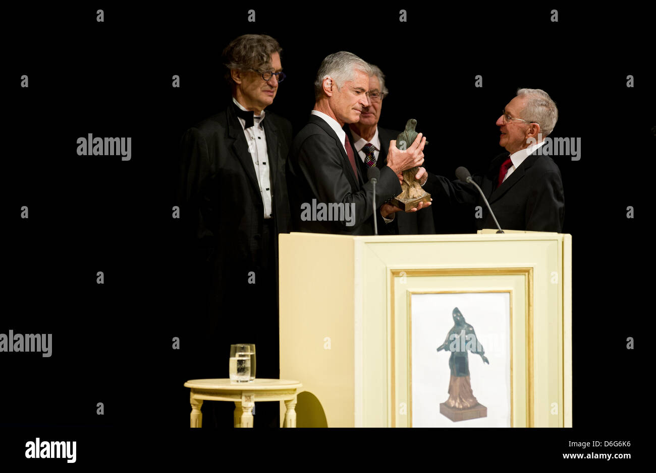 American documentary photographer James Nachtwey (2 L) receives the 3rd international peace prize, the Dresden Prize, from Hans-Joachim Dietze (R), who took unique photos of the firestorm in Dresden when he was 15 in 1945, at the Semper Opera in Dresden, Germany, 11 February 2012. German director Wim Wenders (L) gave the laudatory speech, former Interior Minister Gerhart Baum moder Stock Photo