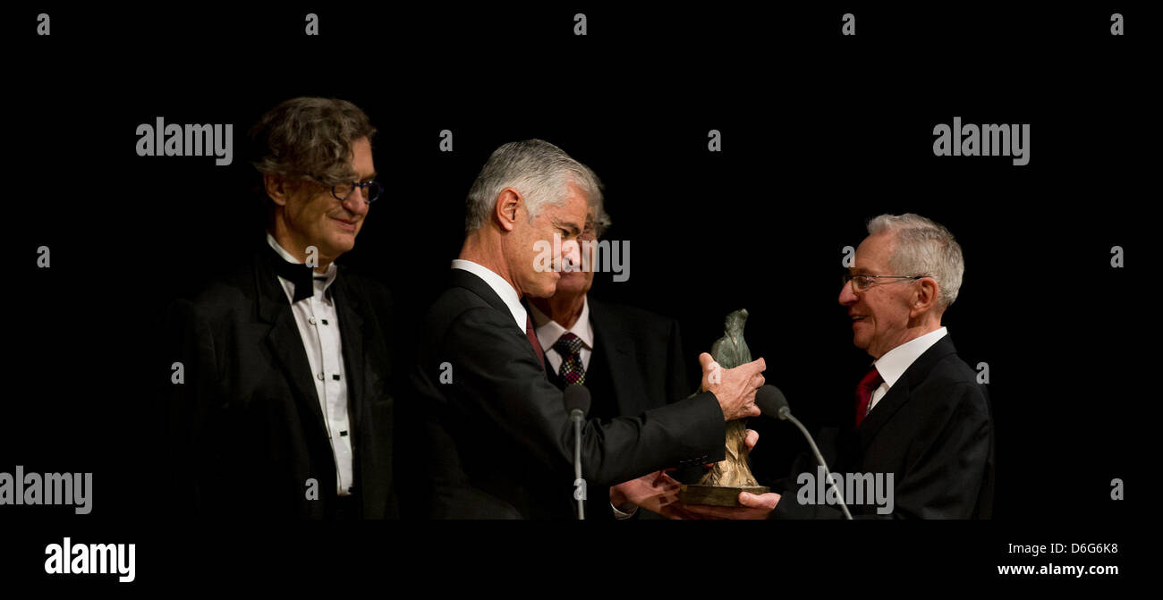 American documentary photographer James Nachtwey (2 L) receives the 3rd international peace prize, the Dresden Prize, from Hans-Joachim Dietze (R), who took unique photos of the firestorm in Dresden when he was 15 in 1945, at the Semper Opera in Dresden, Germany, 11 February 2012. German director Wim Wenders (L) gave the laudatory speech, former Interior Minister Gerhart Baum moder Stock Photo