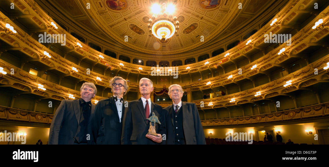 American documentary photographer James Nachtwey (3-L) poses during the award ceremony for the 3rd international peace prize, the Dresden Prize, with commercial director of the Saxon State Opera Wolfgang Rothe (L), German director Wim Wenders (2-L) and former Interior Minister Gerhart Baum (4-L) at the Semper Opera in Dresden, Germany, 11 February 2012. The prize worth 25,000 euros Stock Photo
