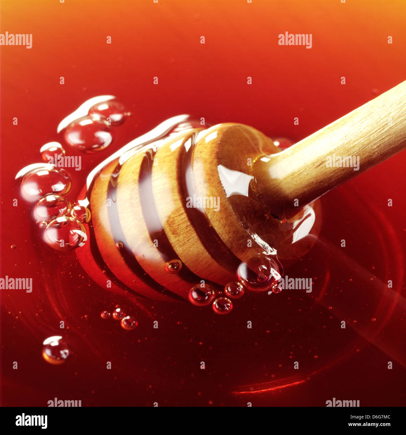 Honey Dipper plunged in honey Stock Photo Alamy
