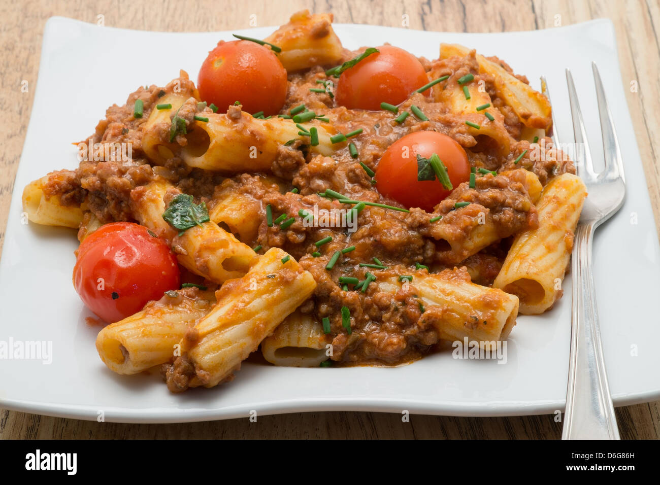 Plate of beef ragu with rigatoni pasta - studio shot Stock Photo