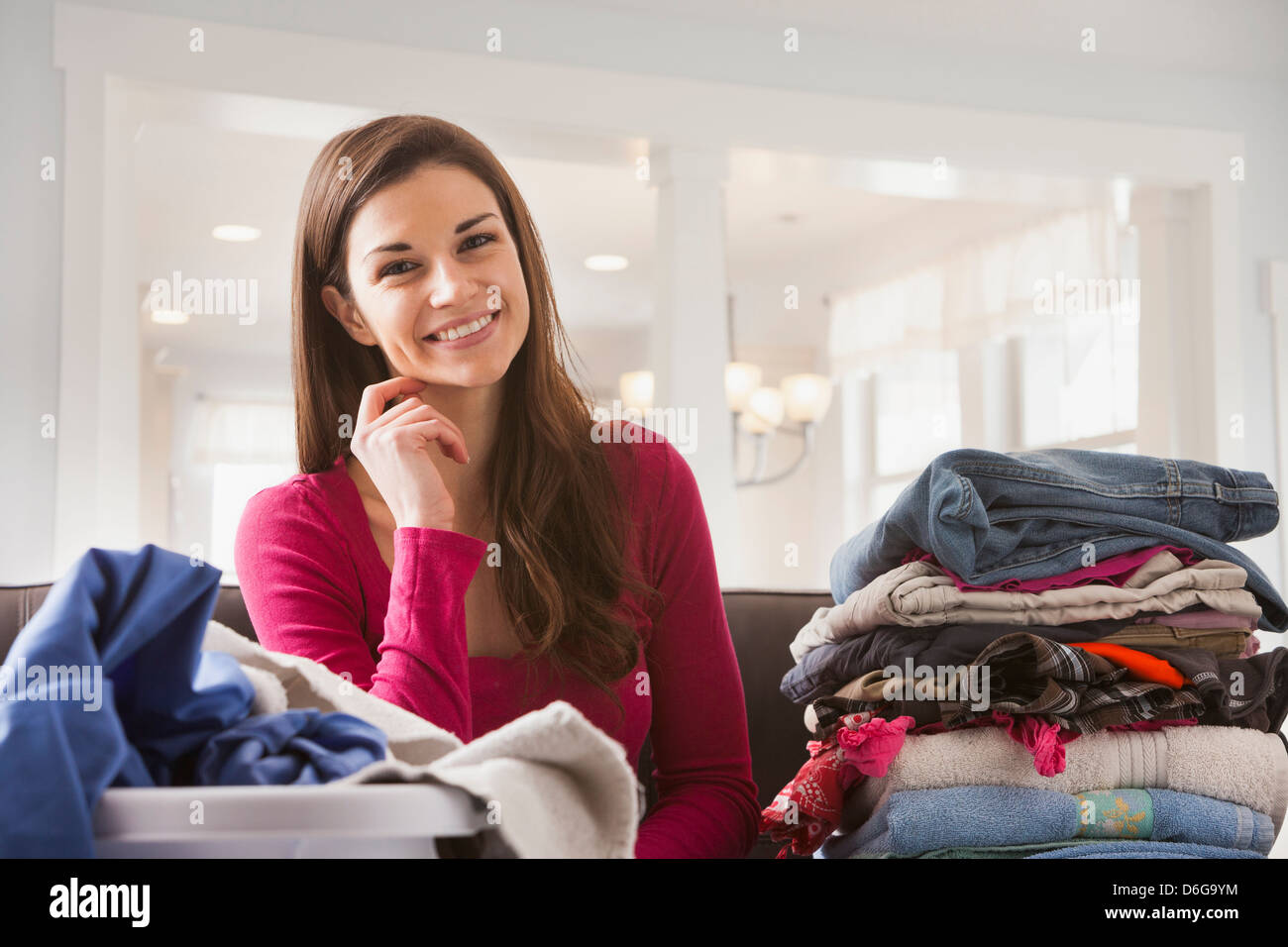 Caucasian woman folding laundry Stock Photo Alamy