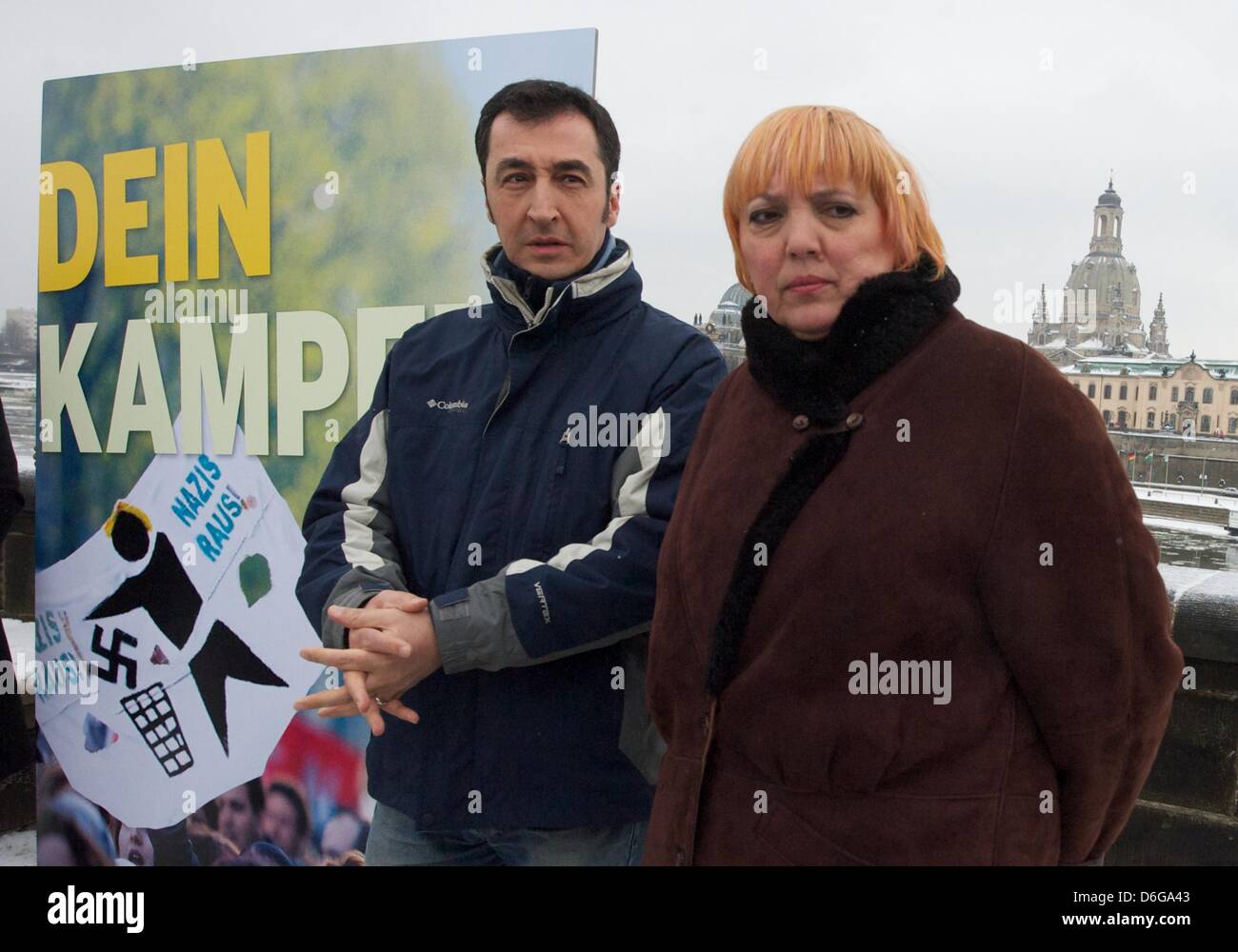 Federal chairman of the German Green Party (Buendnis 90/Die Gruenen) Cem Ozdemir (L) and chairwoman Claudia Roth pose next to an anti-Nazi poster saying 'Dein Kampf' (Your fight) in Dresden, Germany, 13 February 2012.  On 13 February, citizens of Dresden commemorate German victims of the Second World War who died during aerial attacks. Photo: Peter Endig Stock Photo