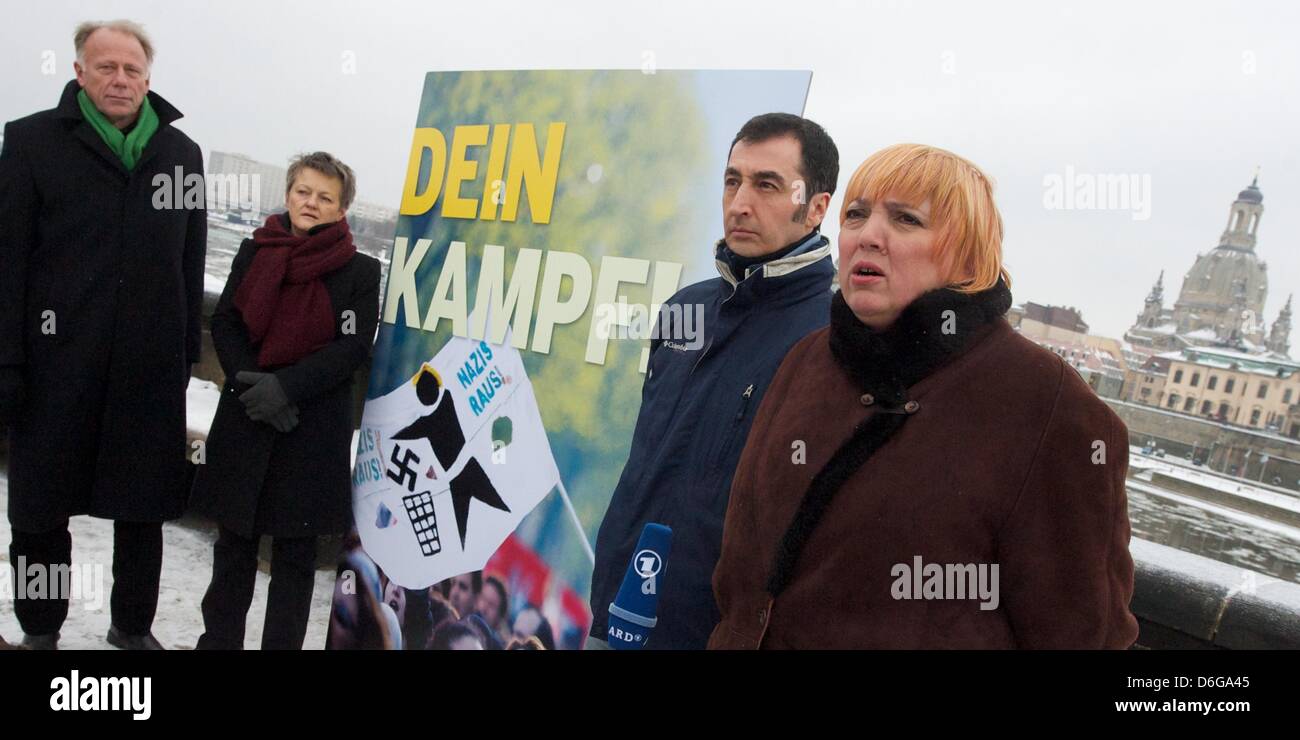 Federal chairman of the German Green Party (Buendnis 90/Die Gruenen) Cem Ozdemir (2-R), chairwoman Claudia Roth (R), Renate Kuenast (2-L) and Juergen Trittin (L) pose next to an anti-Nazi poster saying 'Dein Kampf' (Your fight) in Dresden, Germany, 13 February 2012.  On 13 February, citizens of Dresden commemorate German victims of the Second World War who died during aerial attack Stock Photo