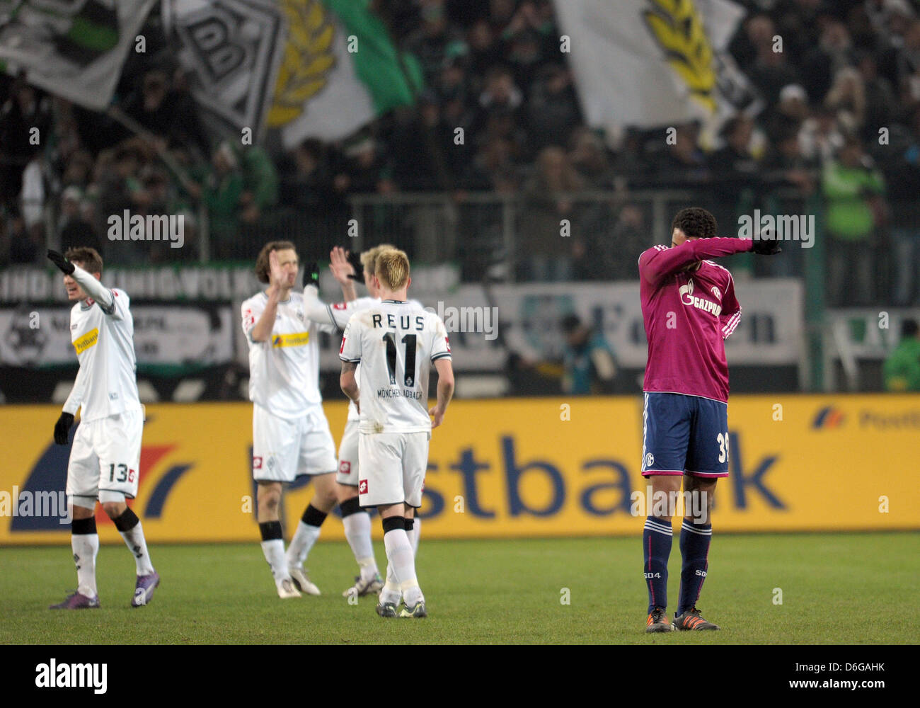 Schalke's Joel Matip (R) stands on the pitch while some of Gladbach's players celebrate after the German Bundesliga soccer match Borussia Moenchengladbach vs FC Schalke 04 at Borussia-Park in Moenchengladbach, Germany, 11 February 2012. Gladbach won 3:0. Photo: Federico Gambarini Stock Photo