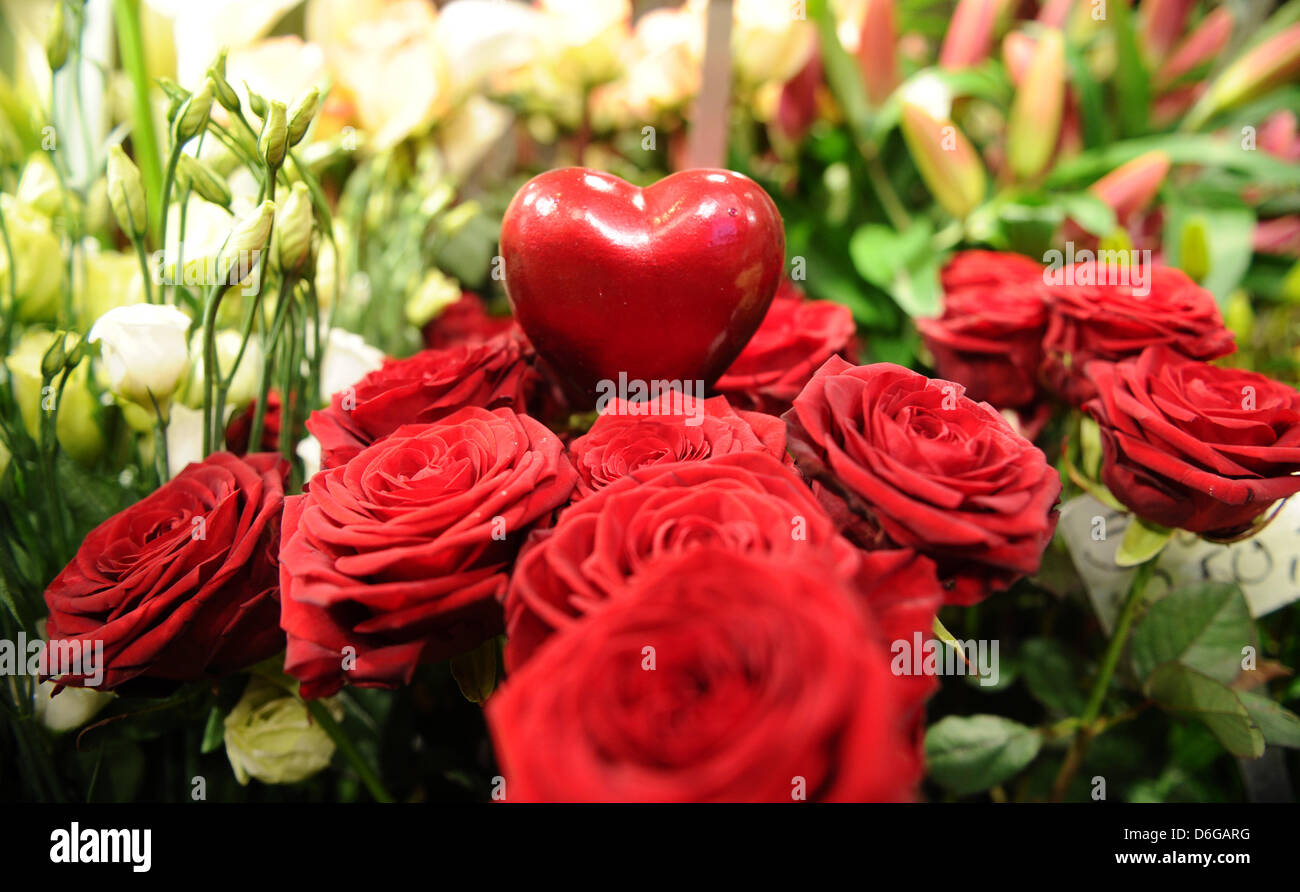 A red heart sticks inside a bouquet of red roses in a flower shop in Hamburg, Germany, 13