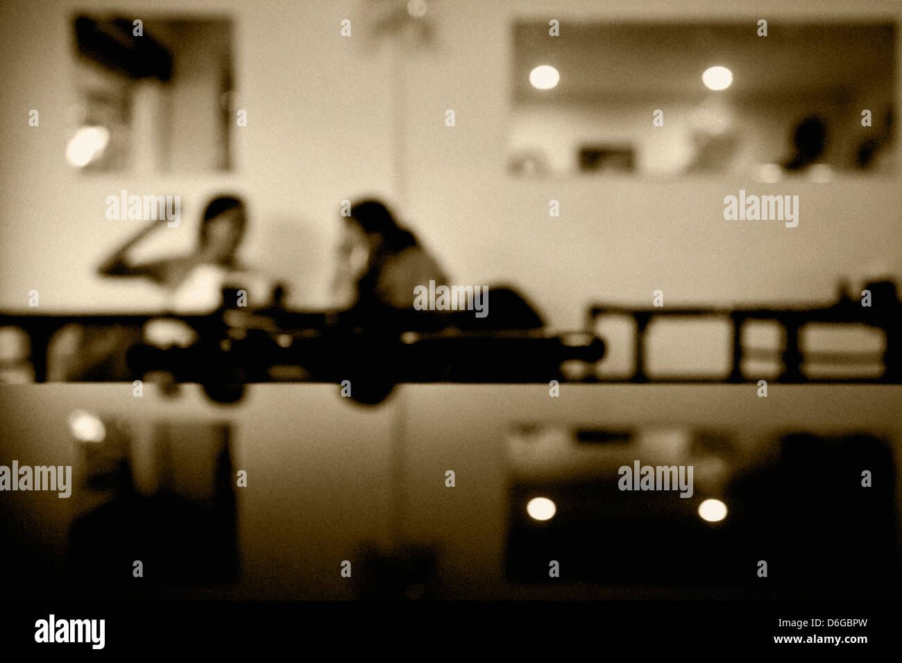 Generic shot of a moody scene where a couple of ladies chatting over a coffee in a Goan Cafe sepia toned Stock Photo