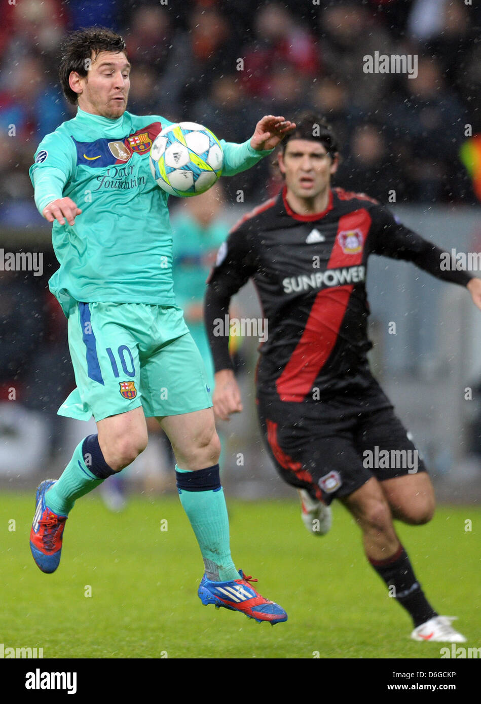 Barcelona's Lionel Messi (L) and Vedran Corluka of Leverkusen vie for the ball during the Champions League round of sixteen first leg soccer match between Bayer Leverkusen and FC Barcelona at the BayArena in Leverkusen, Germany, 14 February 2012. Photo: Federico Gambarini dpa/lnw  +++(c) dpa - Bildfunk+++ Stock Photo