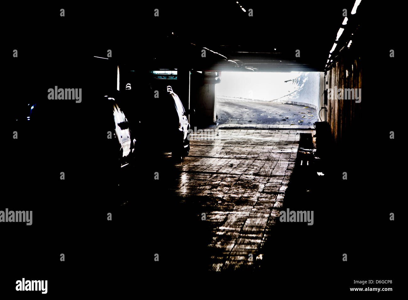 Generic photograph of daylight coming between the dark shadows of an under ground vehicle parking facility in Bombay, India Stock Photo