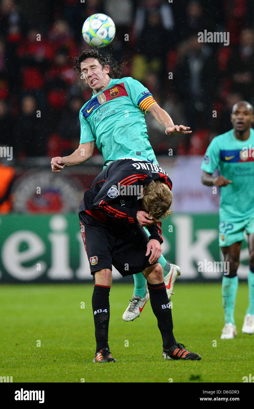 Barcelona's Carles Puyol vies for the ball with Leverkusen's Stefan Kiessling (front) during the Champions League match between Bayer Leverkusen and FC Barcelona at BayArena in Leverkusen, Germany, 14 February 2012. Photo: Revierfoto Stock Photo