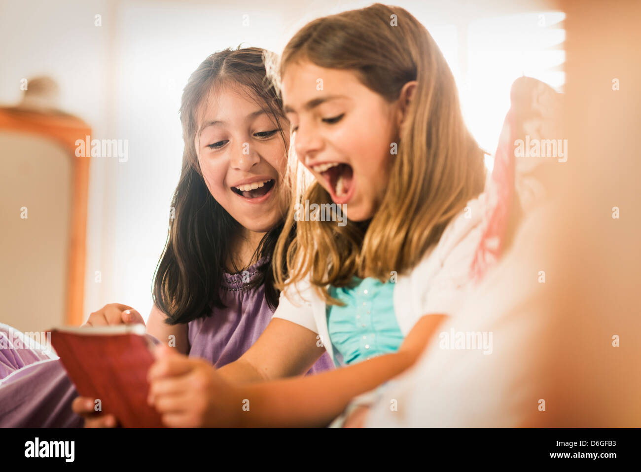 Happy children playing tablet together hi-res stock photography and ...