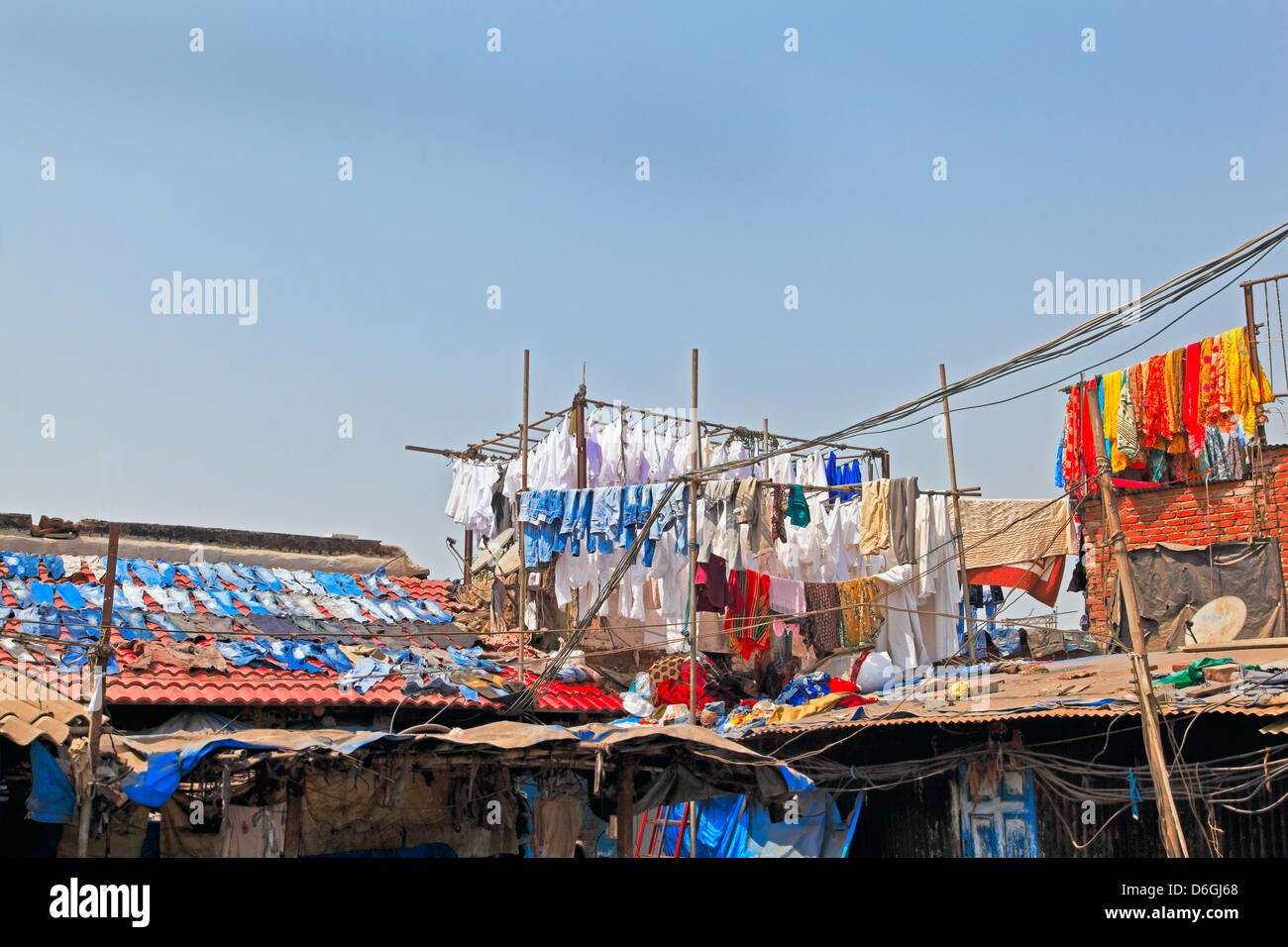 Denim drying on slate roofs and clothes in hand made bamboo racks at commercial laundry in Bombay India Stock Photo