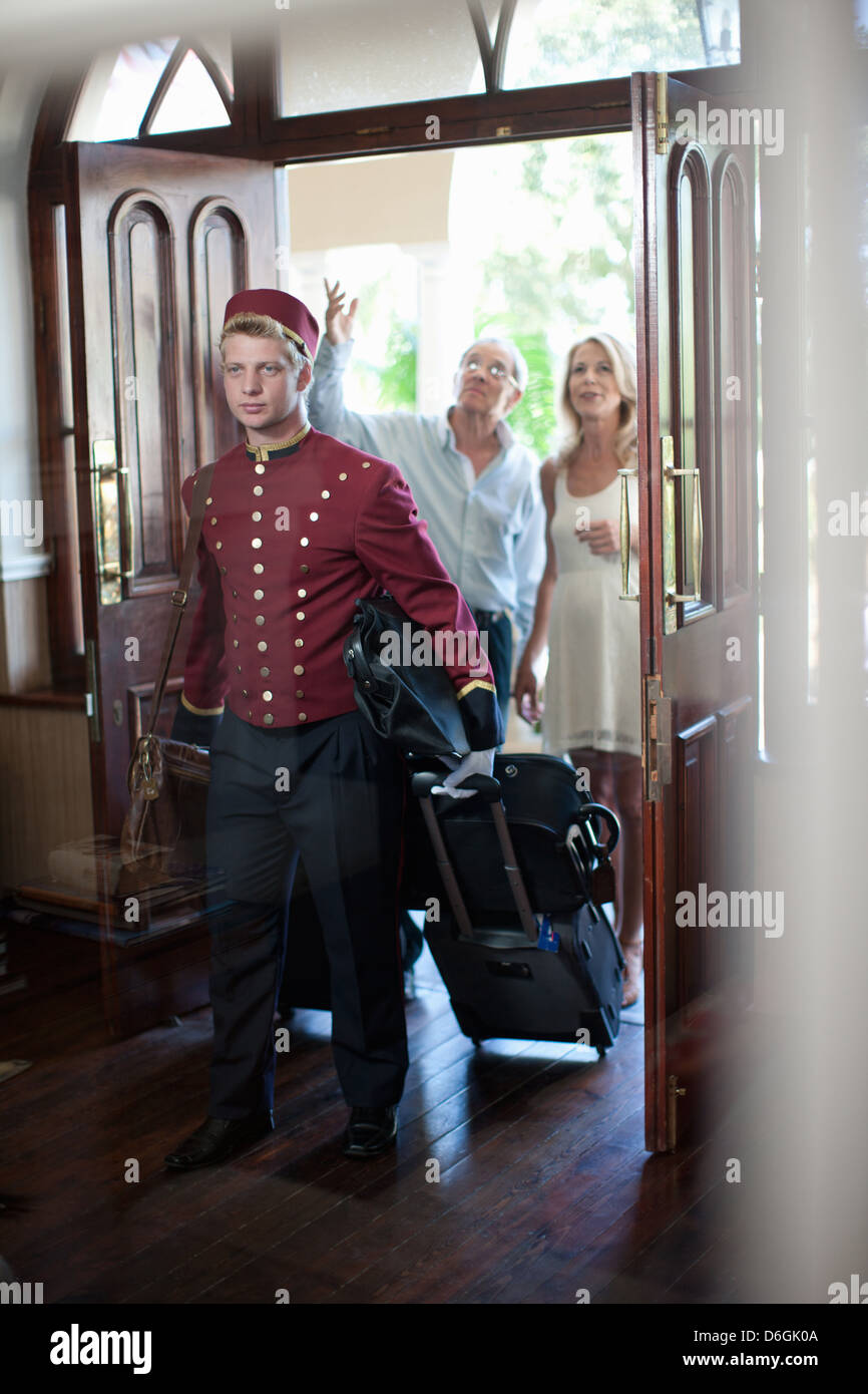 bellhop-carrying-luggage-in-hotel-D6GK0A