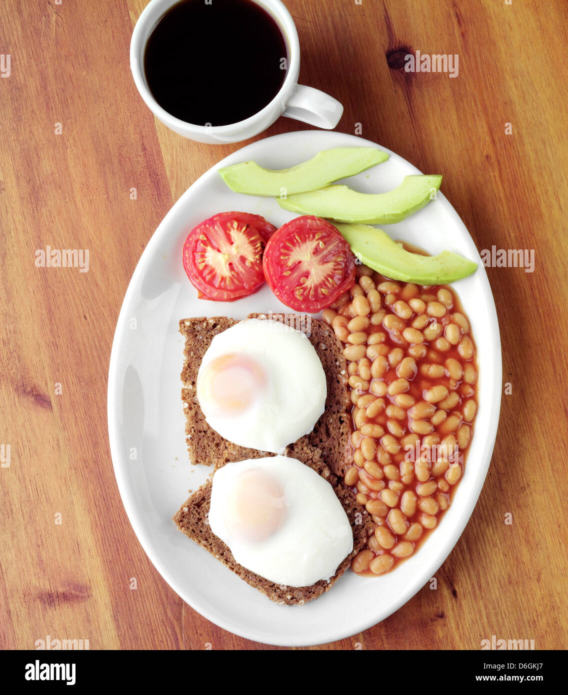 Fried Eggs on Toast and Baked Beans for Breakfast Stock Photo
