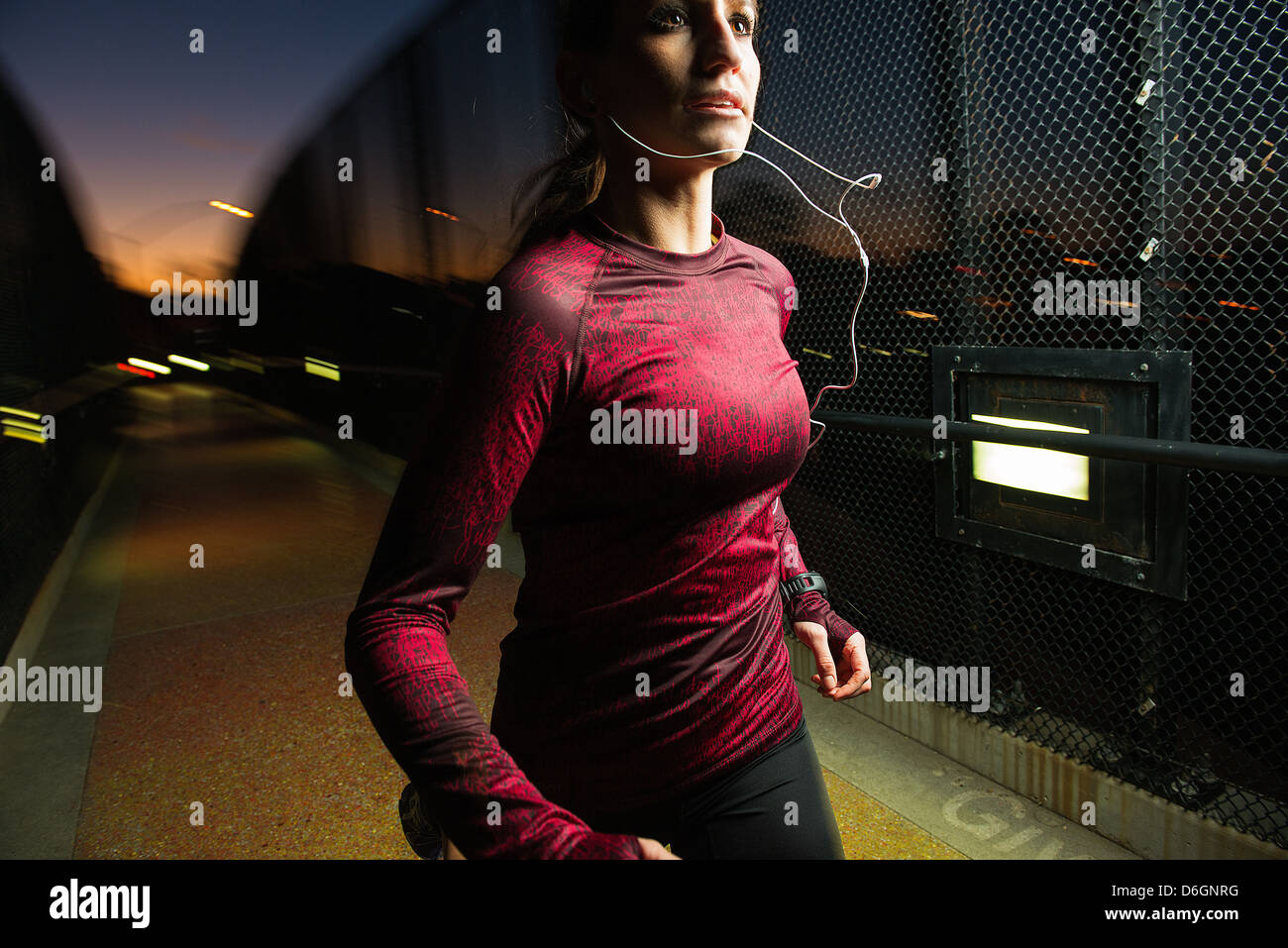 Woman running on pedestrian bridge Stock Photo