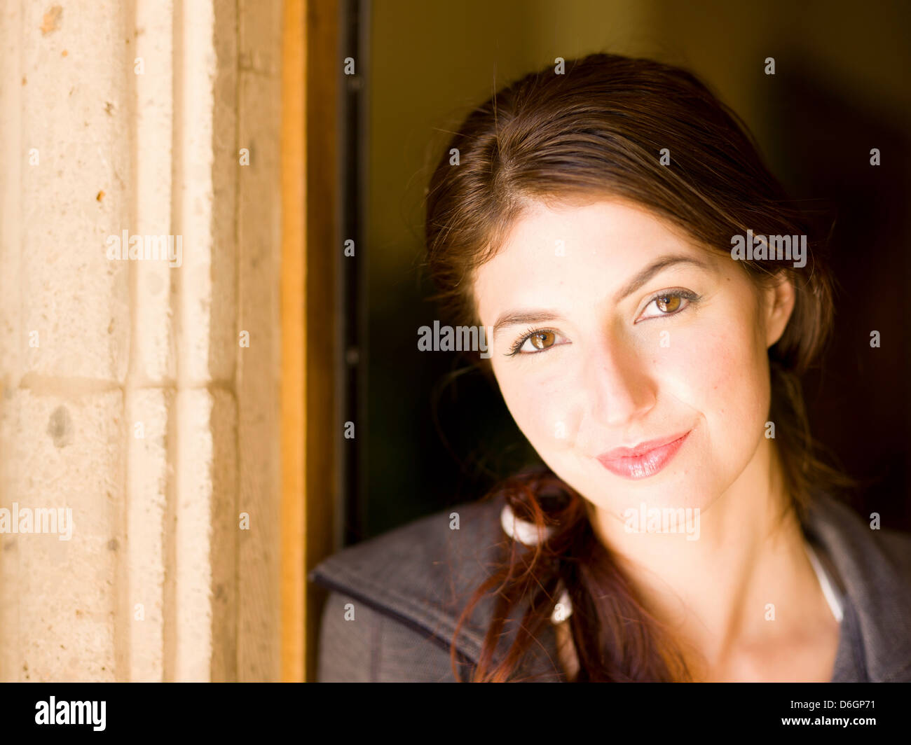 Smiling woman standing in doorway Stock Photo - Alamy