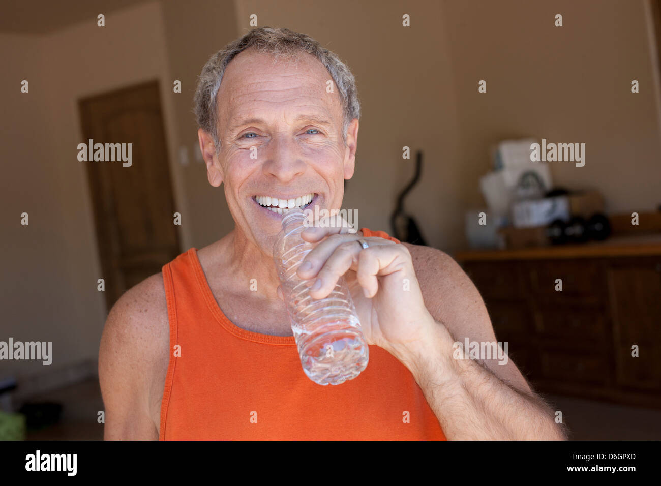 Older man drinking water bottle Stock Photo - Alamy