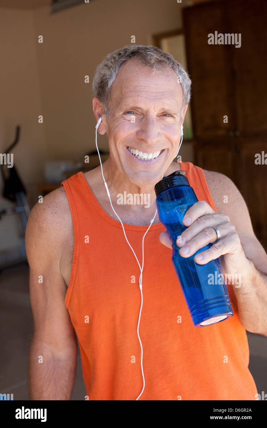 Older man drinking water bottle Stock Photo - Alamy
