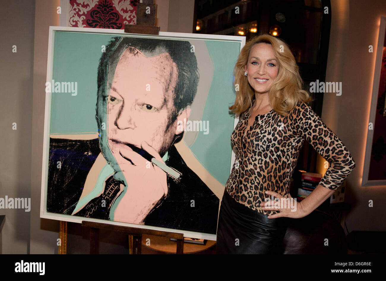 Jerry Hall, ex-wife of Mick Jagger, stands next to a portrait of former German Chancellor Willy Brandt by the artist Andy Warhol during the talkshow 'Gottschalk live' of TV presenter and host Thomas Gottschalk in Berlin, Germany, 22 February 2012. it is the 25th anniversary of Warhol's death. Photo: Joerg Carstensen Stock Photo