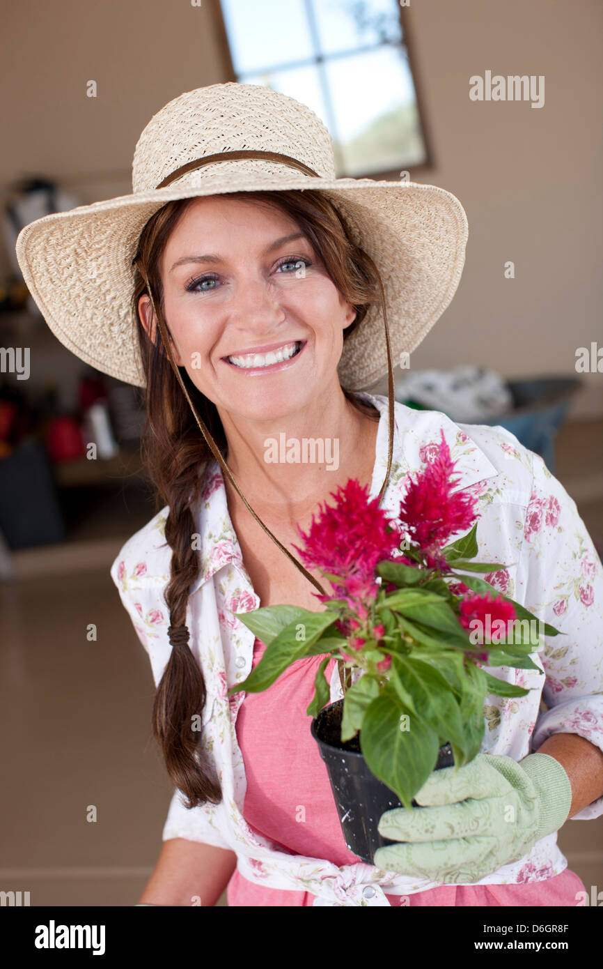 Woman holding potted plant Stock Photo - Alamy