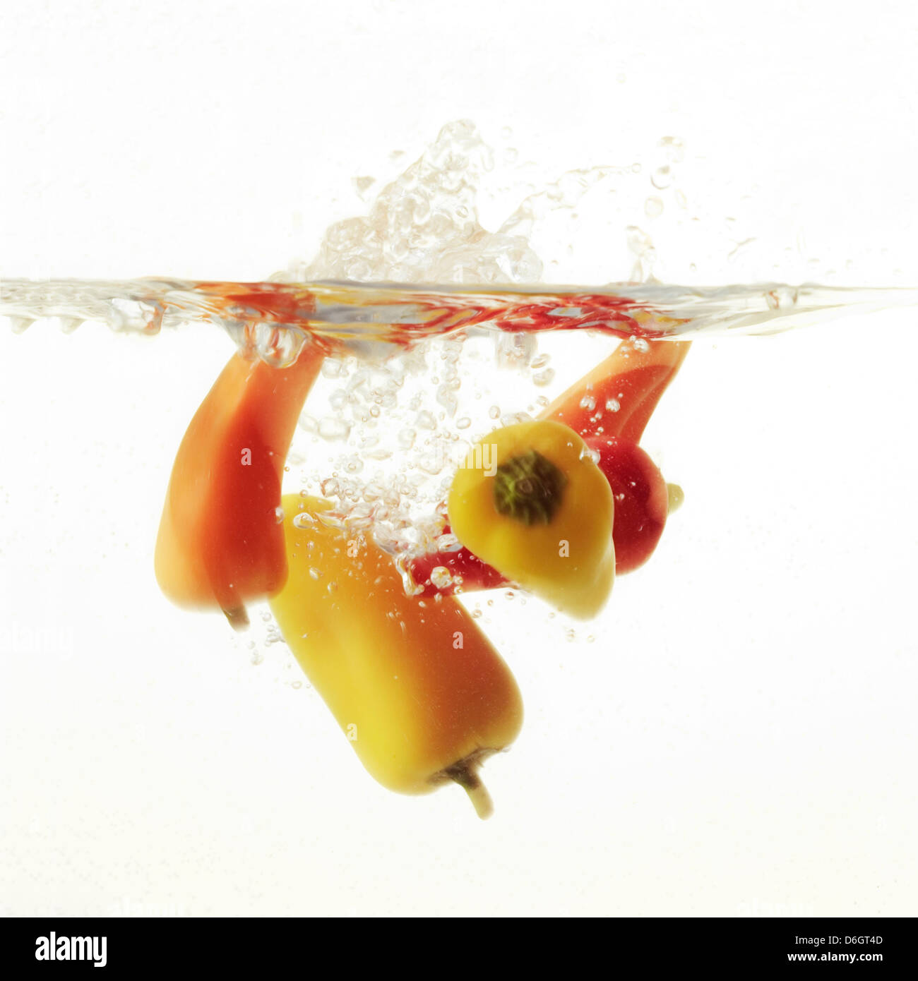 Multi Coloured Chilli Peppers Splashing into Water Stock Photo Alamy