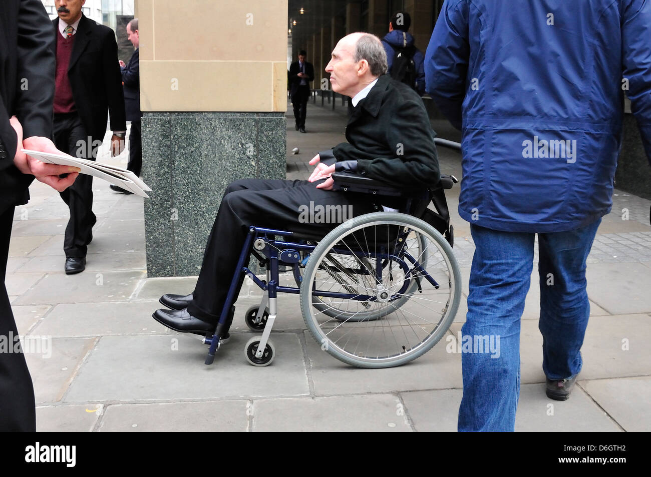 Sir Frank Williams waiting for his car after Margaret Thatcher's funeral at St Paul's Cathedral - April 17th 2013 Stock Photo