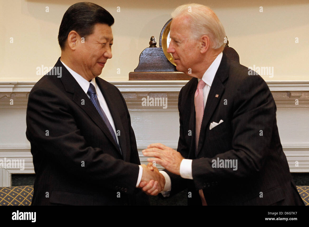 United States Vice President Joe Biden (R) and Vice President Xi Jinping of China shake hands before  an expanded bilateral meeting with other U.S. and Chinese officials in the Roosevelt Room at the White House in Washington, DC, USA, 14 February 2012. While in Washington, Vice President Xi will meet with Biden, President Barack Obama and other senior Administration officials to di Stock Photo