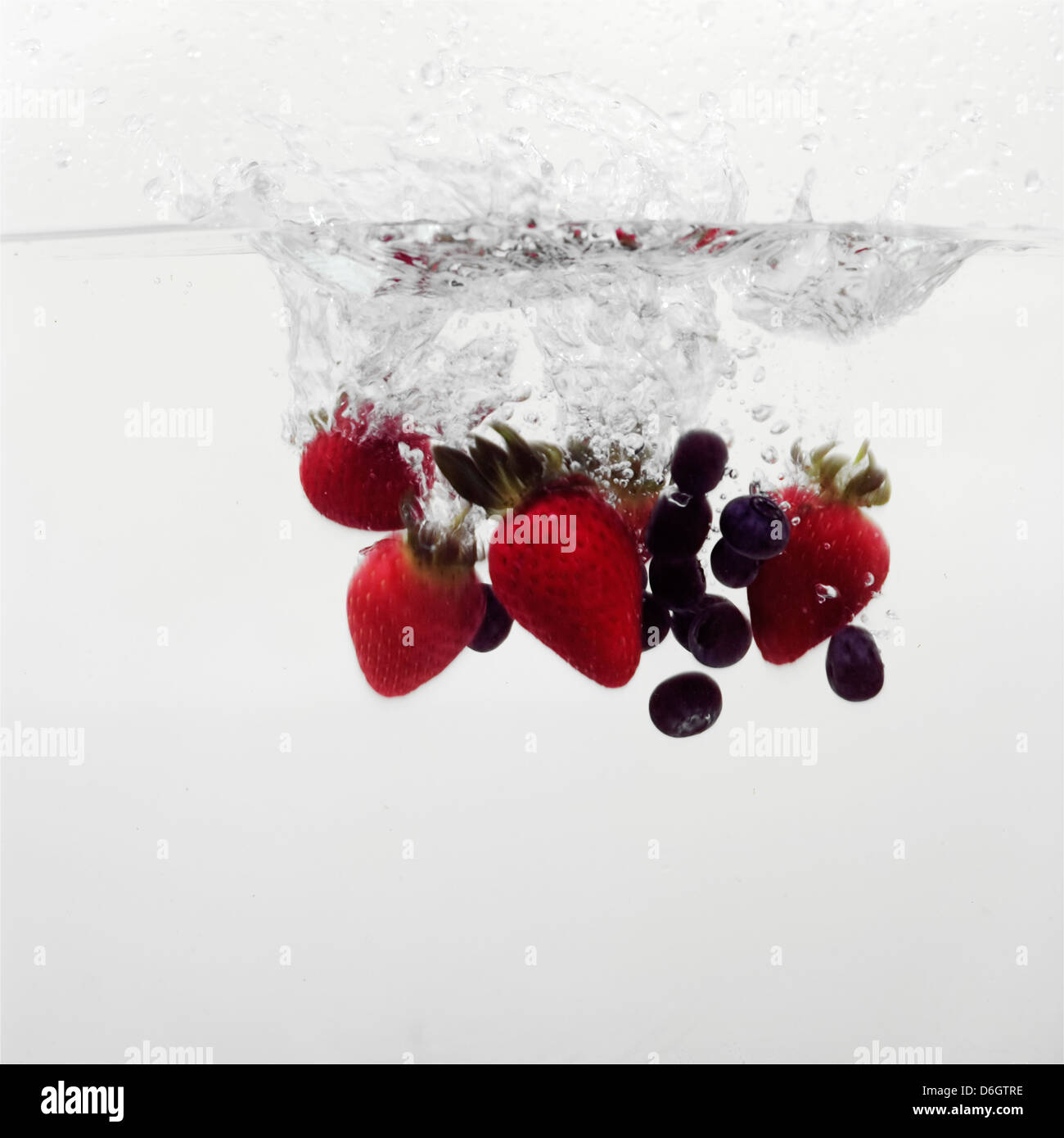 Strawberries and Blueberries splashing into water Stock Photo Alamy